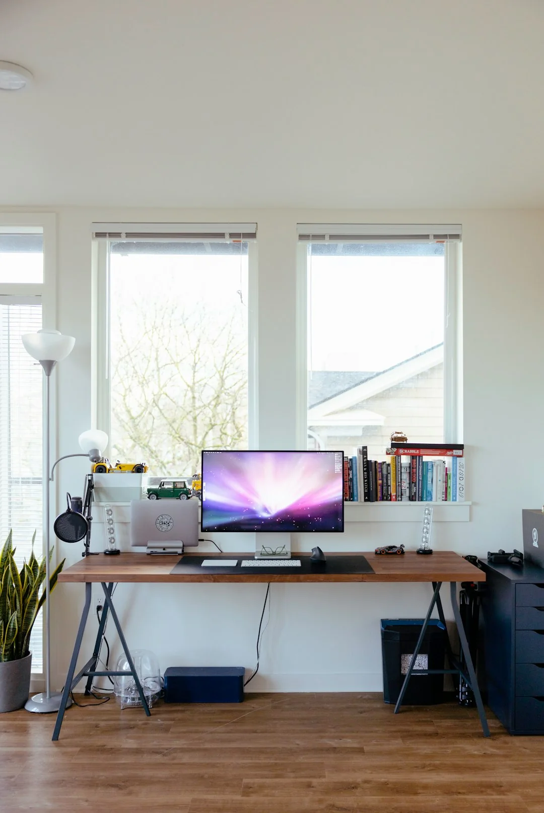 A modern workspace featuring dual computer monitors displaying web design projects, emphasizing technology and productivity.